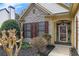 Inviting entryway showcases stone accents, decorative shutters, and a beautifully adorned front door at 918 Bridge Mill Ave, Canton, GA 30114