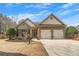 Charming home featuring stone accents, two-car garage, and manicured landscaping under a clear blue sky at 918 Bridge Mill Ave, Canton, GA 30114