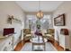 Cozy sunroom with floral chairs, decorative chandelier, and a light-filled atmosphere at 918 Bridge Mill Ave, Canton, GA 30114