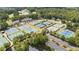 Aerial shot showcasing multiple well-maintained tennis courts surrounded by lush trees and condo buildings at 918 Bridge Mill Ave, Canton, GA 30114