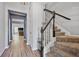 Hallway with staircase and hardwood style flooring leading into the home at 1832 Willow Branch Nw Ln # H, Kennesaw, GA 30152