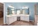 Bright bathroom featuring double sinks, a large mirror, and wood-look tile flooring at 4275 Chastain Pointe Nw, Kennesaw, GA 30144