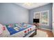 Bedroom with hardwood floors and a large window that provides ample natural light at 4275 Chastain Pointe Nw, Kennesaw, GA 30144