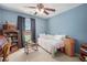 Cozy bedroom with carpet, a ceiling fan and charming decor elements at 4275 Chastain Pointe Nw, Kennesaw, GA 30144