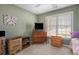 Bedroom with cozy furnishings, including vintage wooden dresser, perfect for a guest room at 4275 Chastain Pointe Nw, Kennesaw, GA 30144