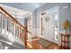 Bright foyer with hardwood floors, staircase, and dining room view at 4275 Chastain Pointe Nw, Kennesaw, GA 30144