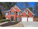 Stately two-story brick home featuring a well-manicured lawn and a two-car garage at 4275 Chastain Pointe Nw, Kennesaw, GA 30144