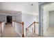 Upstairs hallway with carpet and wooden railing, leading to various rooms in the home at 4275 Chastain Pointe Nw, Kennesaw, GA 30144