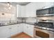 Bright kitchen featuring white cabinetry, stainless steel appliances, and hardwood flooring at 4275 Chastain Pointe Nw, Kennesaw, GA 30144