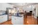 Open-concept living area with modern kitchen and dining space with hardwood floors at 4275 Chastain Pointe Nw, Kennesaw, GA 30144