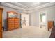 Large main bedroom with tray ceilings, carpet, and access to a bathroom at 4275 Chastain Pointe Nw, Kennesaw, GA 30144