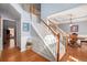 Elegant staircase with carpet runner and view into formal dining room at 4275 Chastain Pointe Nw, Kennesaw, GA 30144