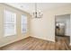 Dining area with hardwood floors features modern lighting fixtures and is near a modern kitchen at 4593 Parkway Cir, Atlanta, GA 30349