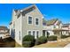 Light green two-story home featuring a balcony, multiple windows, and attractive landscaping at 4593 Parkway Cir, Atlanta, GA 30349