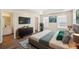 Spacious main bedroom with tray ceiling, wood floors, and ensuite bathroom at 4593 Parkway Cir, Atlanta, GA 30349