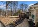 Backyard landscape with a deck featuring a gazebo and chairs near the house at 2984 Superior Dr, Dacula, GA 30019