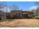 Exterior view of the house with a large, partially shaded backyard and patio at 2984 Superior Dr, Dacula, GA 30019