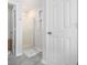 Bright bathroom featuring a glass shower, stylish rug, and neutral color palette at 2984 Superior Dr, Dacula, GA 30019