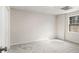 Bright bedroom features neutral carpet, window overlooking outdoors, and a door for easy access at 2984 Superior Dr, Dacula, GA 30019