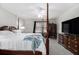 Spacious bedroom with a four-poster bed, dresser, and carpeted floor at 2984 Superior Dr, Dacula, GA 30019