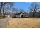 Side view of house featuring a large lawn with driveway and garage, beautifully landscaped at 2984 Superior Dr, Dacula, GA 30019