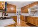 Well-lit kitchen with natural wood cabinets, white countertops, stainless steel appliances, and hardwood floors at 2984 Superior Dr, Dacula, GA 30019