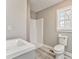 Bathroom features a gray vanity with a white sink, a toilet, and a shower at 322 Corley Cir, Hiram, GA 30141