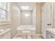 Bathroom with soaking tub, toilet, gray vanity, and a skylight at 322 Corley Cir, Hiram, GA 30141