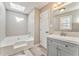 Well-lit bathroom featuring a soaking tub, vanity with gray cabinets, and modern fixtures at 322 Corley Cir, Hiram, GA 30141