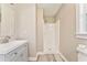 Neutral bathroom features a gray vanity, a shower, and vinyl plank flooring at 322 Corley Cir, Hiram, GA 30141