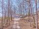 Exterior of home with a driveway leading up to a two-car garage, surrounded by a wooded landscape at 322 Corley Cir, Hiram, GA 30141