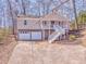 Charming home with stone accents, a two-car garage, and a welcoming front porch and stairway at 322 Corley Cir, Hiram, GA 30141