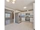 Bright kitchen boasts stainless steel appliances, white cabinets, and tiled floors for a modern and clean aesthetic at 322 Corley Cir, Hiram, GA 30141