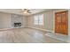 Bright living room featuring a stone fireplace, modern flooring and front door at 322 Corley Cir, Hiram, GA 30141