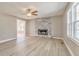 Bright living room with stone fireplace, modern flooring and abundant natural light at 322 Corley Cir, Hiram, GA 30141
