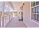 View of the covered front porch with white railings, new storm door, and natural light at 322 Corley Cir, Hiram, GA 30141