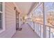 Covered front porch with white railings with new storm door at 322 Corley Cir, Hiram, GA 30141
