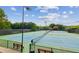 Community tennis courts with well-maintained grounds, benches, and trees at 4220 Cadmium Dr, Cumming, GA 30040