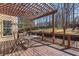 Outdoor living space featuring a pergola-covered deck, table, and chairs at 2162 Pine Mountain Nw Rd, Kennesaw, GA 30152