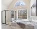 Luxurious bathroom featuring a soaking tub, a large window, and a separate glass shower at 2162 Pine Mountain Nw Rd, Kennesaw, GA 30152