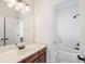 Bathroom features a large mirror, wood cabinet, and a stand-up shower at 2162 Pine Mountain Nw Rd, Kennesaw, GA 30152