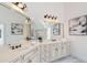 Elegant bathroom with a double sink vanity, granite counters, and decorative lighting fixtures at 2162 Pine Mountain Nw Rd, Kennesaw, GA 30152