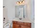 Bathroom featuring a vanity with a white countertop, wooden cabinets, a mirror, toilet, and a shower/bath combo at 2162 Pine Mountain Nw Rd, Kennesaw, GA 30152