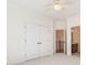 Bright bedroom features neutral carpet, white walls and trim, and a ceiling fan at 2162 Pine Mountain Nw Rd, Kennesaw, GA 30152