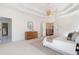 Spacious primary bedroom with tray ceilings, a ceiling fan, large windows, and hardwood flooring at 2162 Pine Mountain Nw Rd, Kennesaw, GA 30152