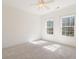 Bright bedroom features neutral carpet, white walls, and two windows offering natural light at 2162 Pine Mountain Nw Rd, Kennesaw, GA 30152