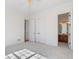 Bright bedroom featuring neutral walls, carpet, a ceiling fan, and a door leading into a private ensuite bathroom at 2162 Pine Mountain Nw Rd, Kennesaw, GA 30152