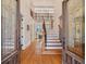 Elegant foyer with hardwood floors, staircase, and decorative glass front doors leading into the home at 2162 Pine Mountain Nw Rd, Kennesaw, GA 30152