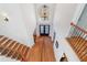 Grand foyer featuring a tall ceiling with a chandelier, staircase with metal spindles, and wood flooring at 2162 Pine Mountain Nw Rd, Kennesaw, GA 30152