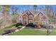 Well-maintained brick home with manicured lawn and mature trees at 2162 Pine Mountain Nw Rd, Kennesaw, GA 30152
